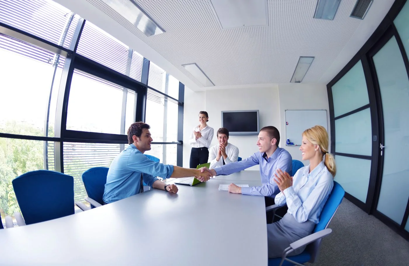 Sales team meeting a customer, with the deal tracked in a CRM